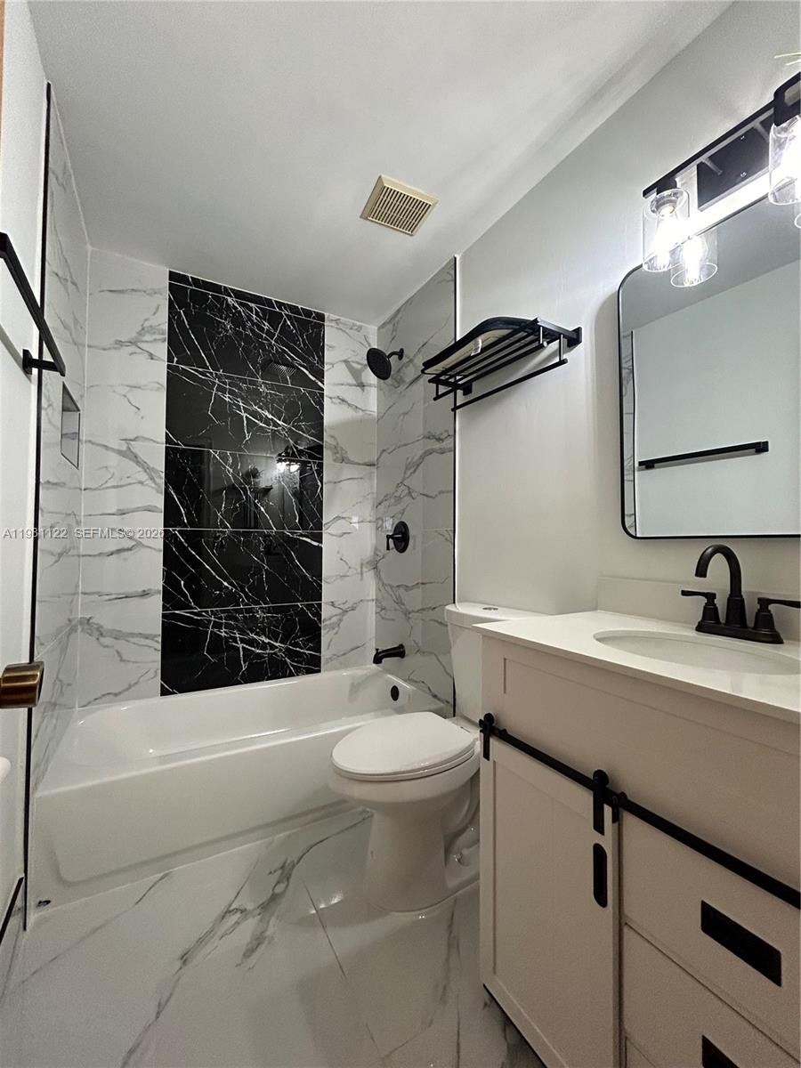 10818 Southwest 72nd Street, Unit 154 Miami, FL 33173 - Photo 7 of 28 a bathroom with a sink a toilet and shower