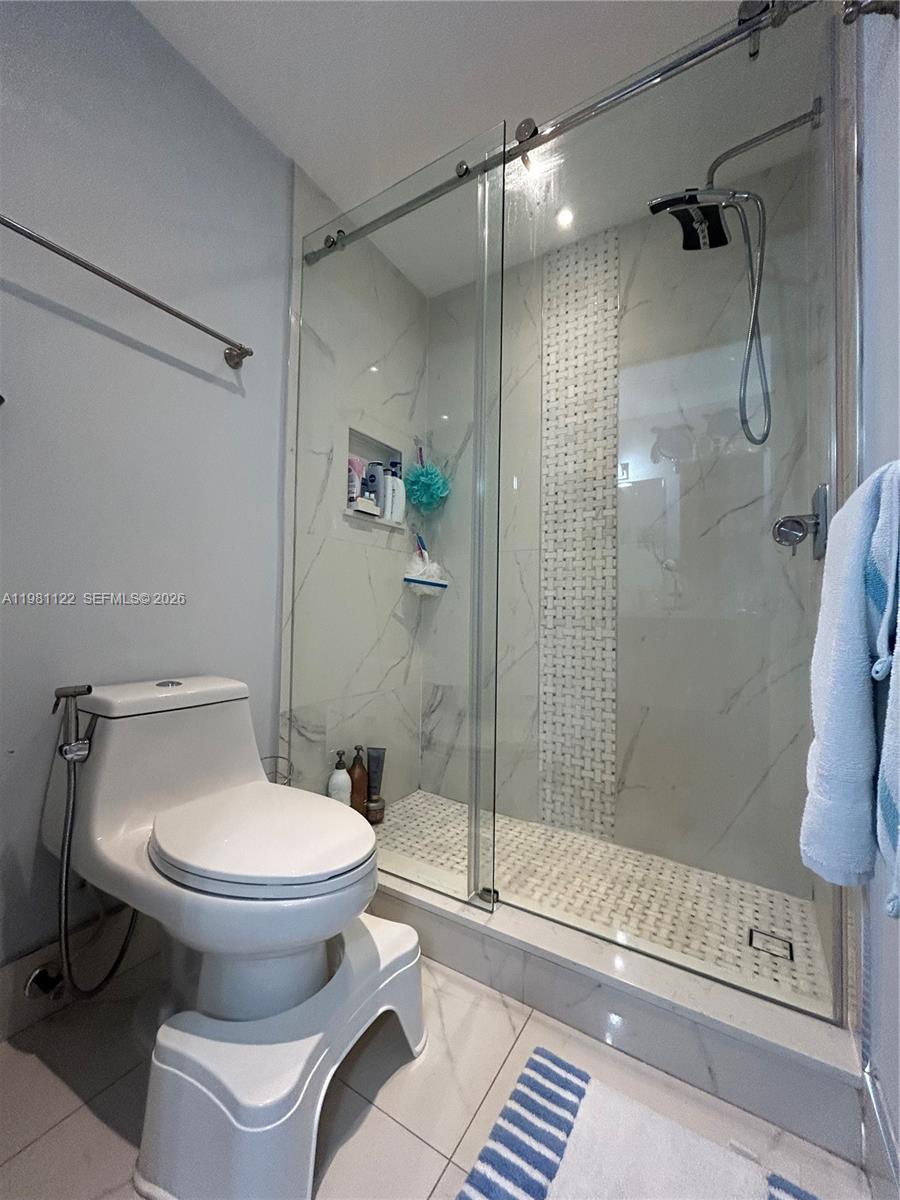 10818 Southwest 72nd Street, Unit 154 Miami, FL 33173 - Photo 8 of 28 a bathroom with a toilet and a shower