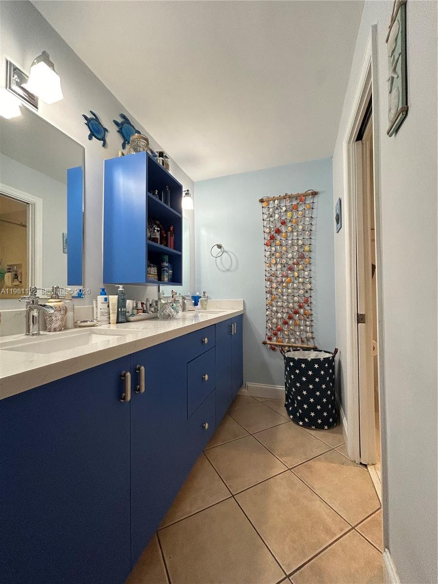 10818 Southwest 72nd Street, Unit 154 Miami, FL 33173 - Photo 9 of 28 a bathroom with a sink vanity and a mirror