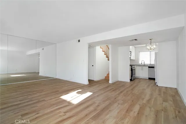a view of a kitchen with wooden floor and a kitchen