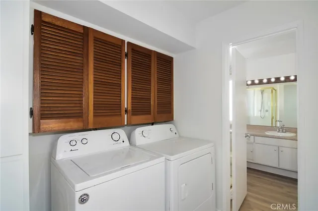 a view of bathroom with a sink and a washer dryer