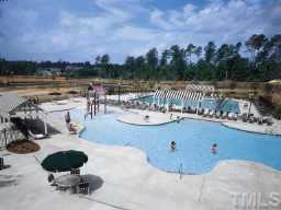 12504 Angel Road Raleigh, NC 27606 - Photo 4 of 8 a view of a swimming pool and lounge chair
