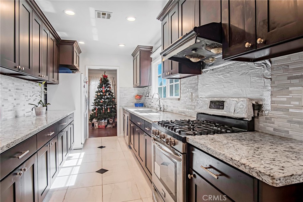 3025 Halsey Avenue Arcadia, CA 91006 - Photo 13 of 42 a kitchen with stainless steel appliances granite countertop a stove and a sink