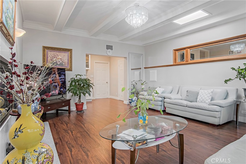 3025 Halsey Avenue Arcadia, CA 91006 - Photo 24 of 42 a living room with furniture flowers and a chandelier