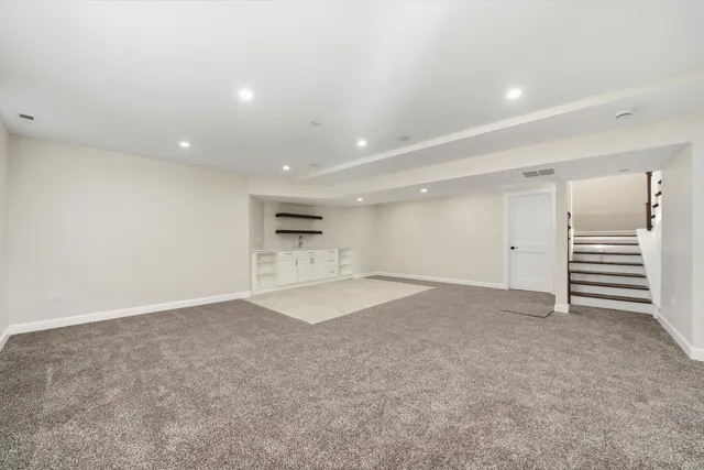 an empty room with a kitchen and a sink