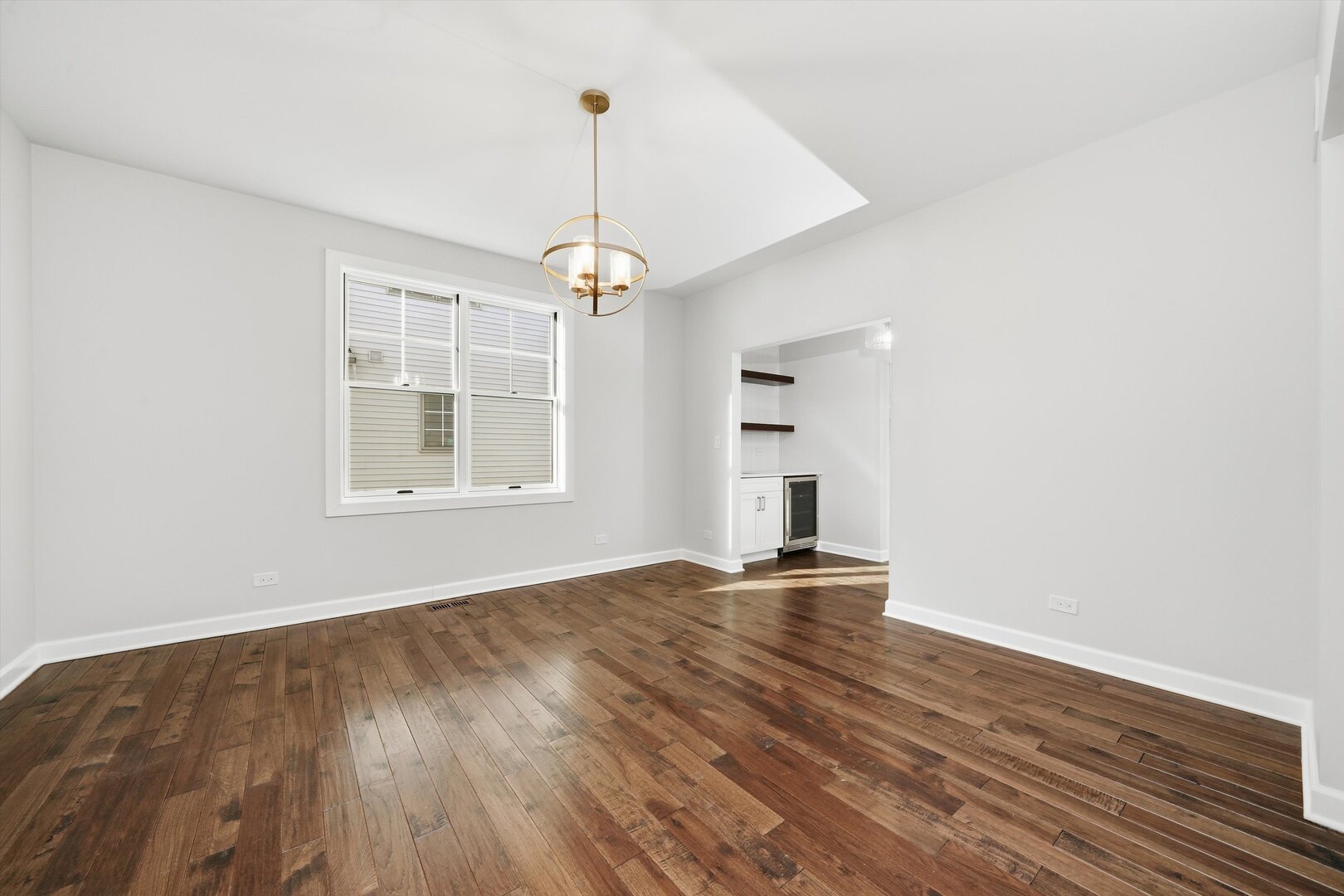 926 East Crest Avenue Addison, IL 60101 - Photo 14 of 34 a view of an empty room with window and wooden floor