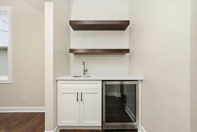 a large kitchen with stainless steel appliances granite countertop a lot of counter space and wooden floors