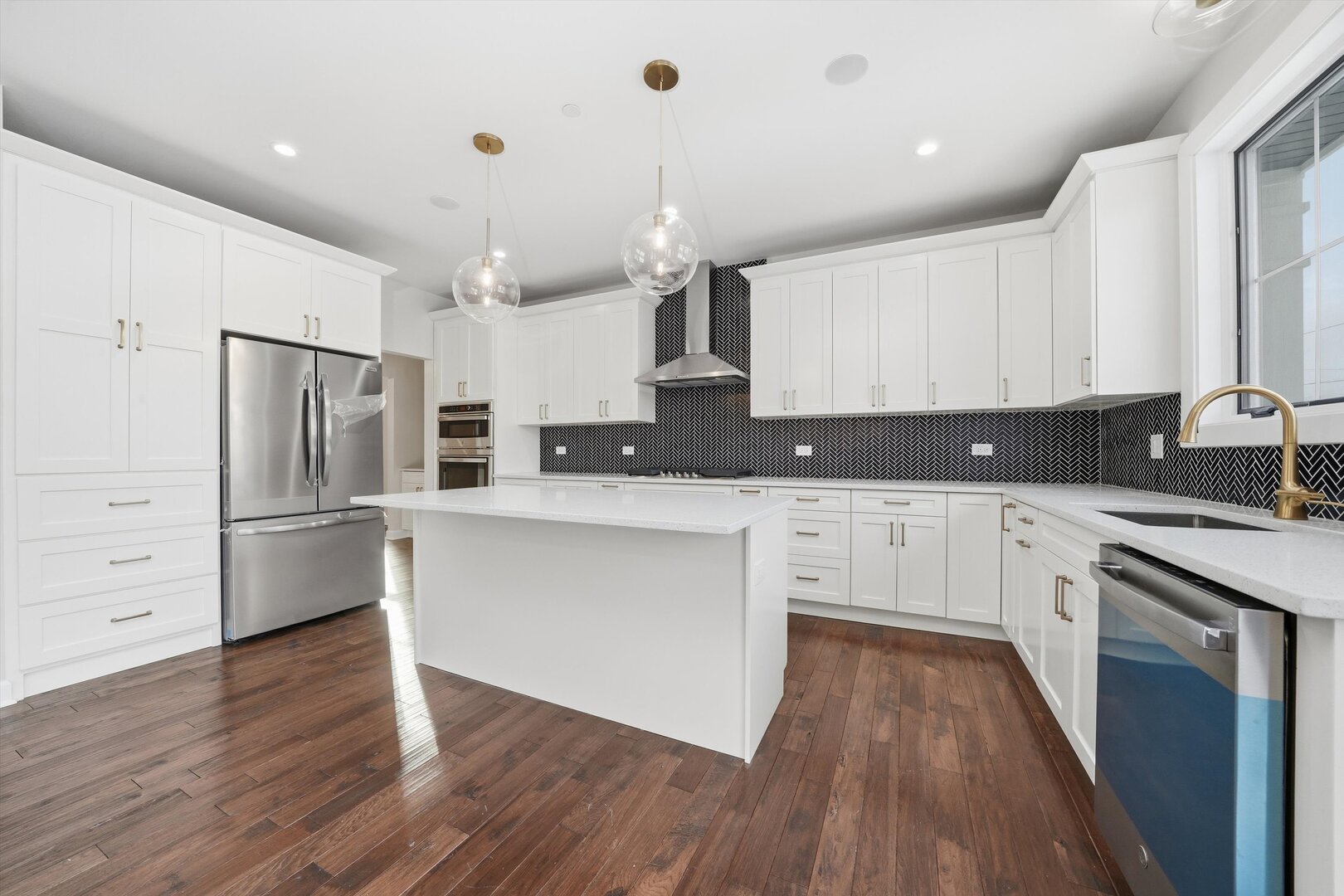 926 East Crest Avenue Addison, IL 60101 - Photo 18 of 34 a kitchen with white cabinets stainless steel appliances and wooden floor