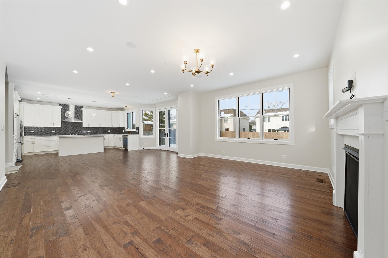 926 East Crest Avenue Addison, IL 60101 - Photo 20 of 34 a view of an empty room and kitchen with wooden floor