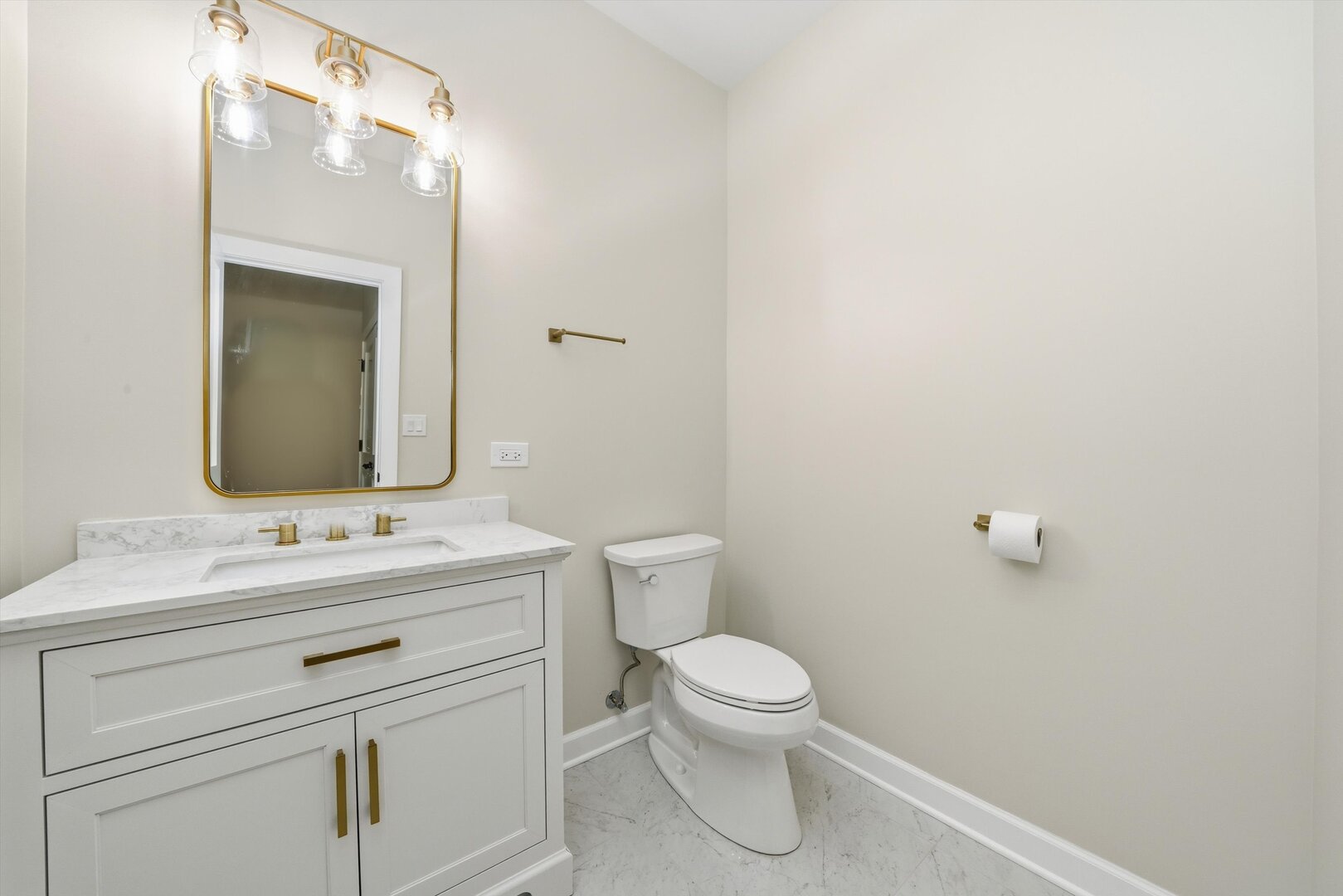 926 East Crest Avenue Addison, IL 60101 - Photo 21 of 34 a bathroom with a toilet sink vanity and mirror