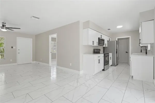 an empty room with white walls and tiles