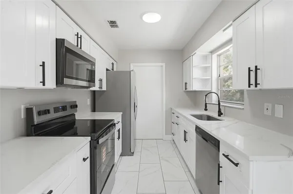 a bathroom with a sink toilet vanity and shower