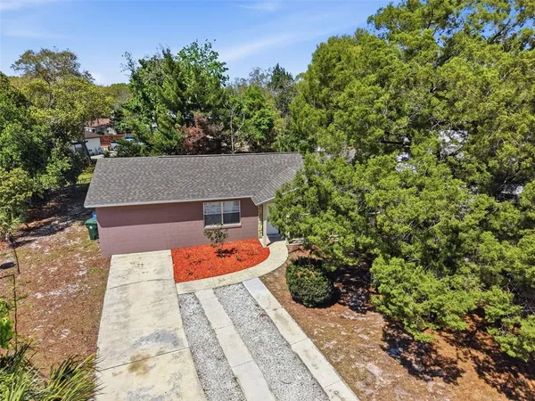 an aerial view of a house with a yard