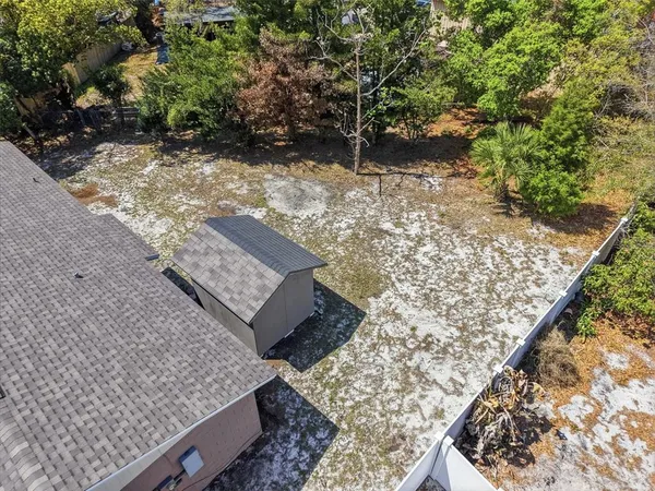 an empty room with windows and ceiling fan