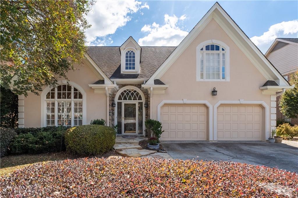 3613 Greystone Circle Chamblee, GA 30341 - Photo 2 of 53 a view of a white house with large windows and a yard