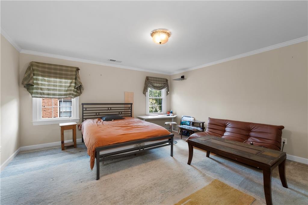 3613 Greystone Circle Chamblee, GA 30341 - Photo 33 of 53 a bedroom with a bed and a chandelier