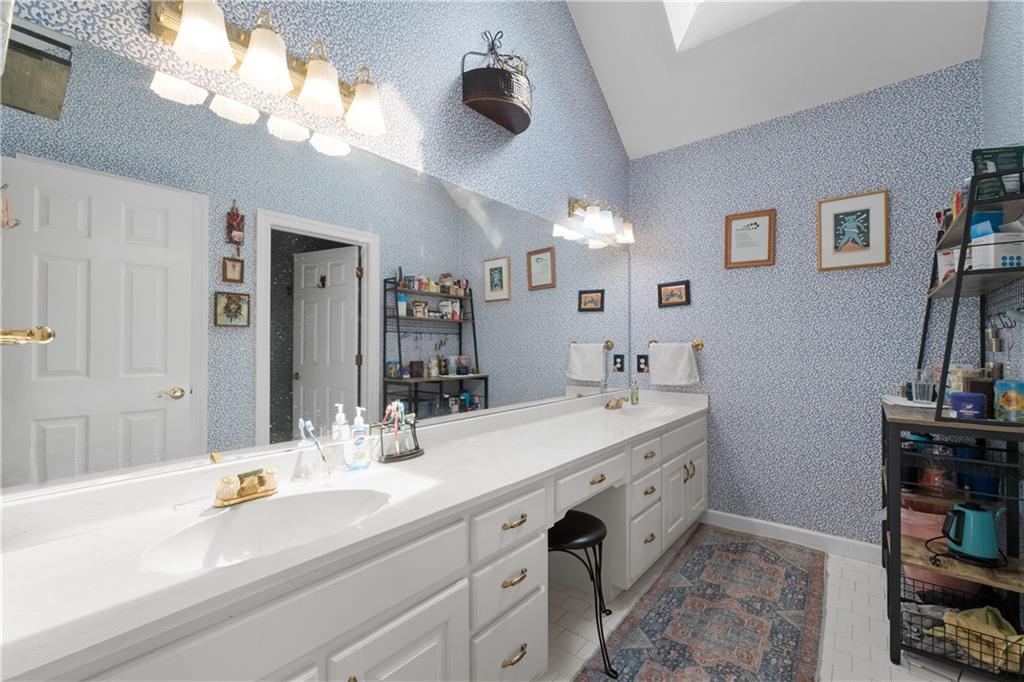 3613 Greystone Circle Chamblee, GA 30341 - Photo 35 of 53 a bathroom with a sink a vanity and a mirror