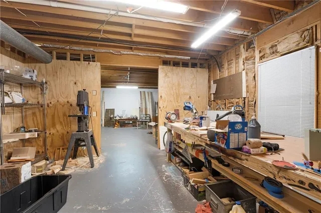 a room with lots of wooden furniture and a chandelier