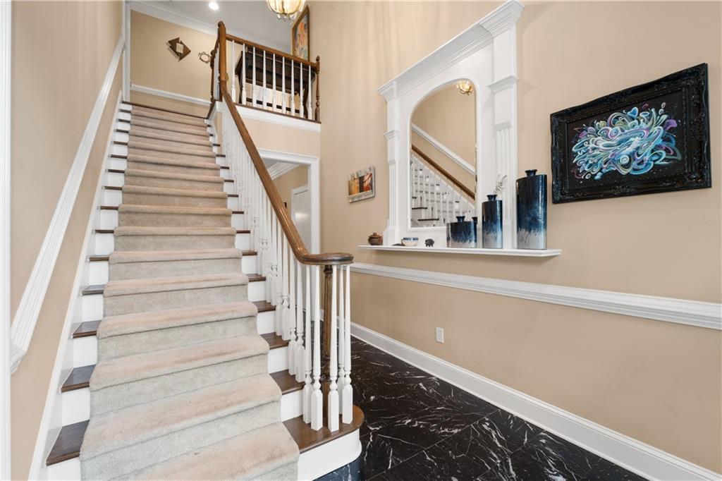 3613 Greystone Circle Chamblee, GA 30341 - Photo 6 of 53 a view of staircase with lots of frames on wall and a black umbrella
