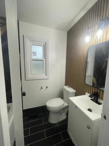 a bathroom with a sink toilet and mirror