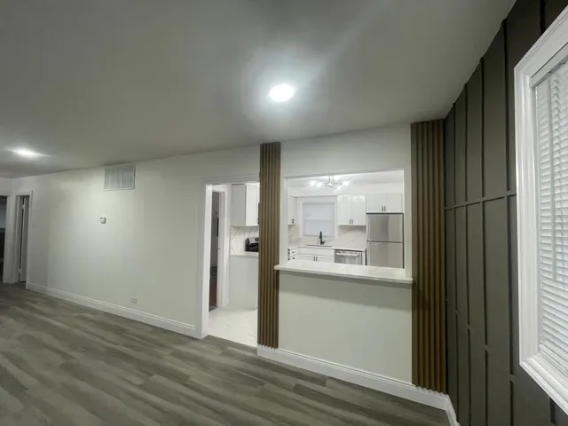 a view of kitchen with wooden floor and windows