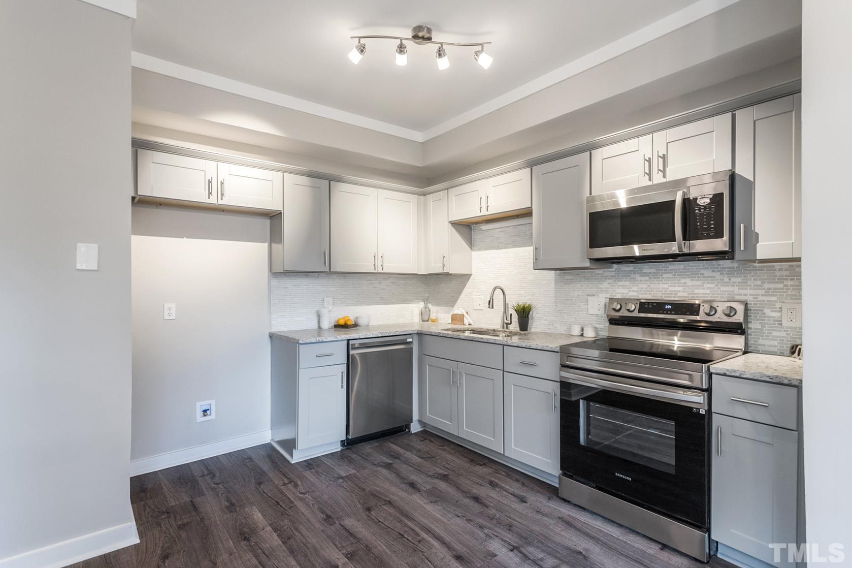 1904 Carthage Circle Raleigh, NC 27604 - Photo 2 of 25 a kitchen with a sink stove and microwave