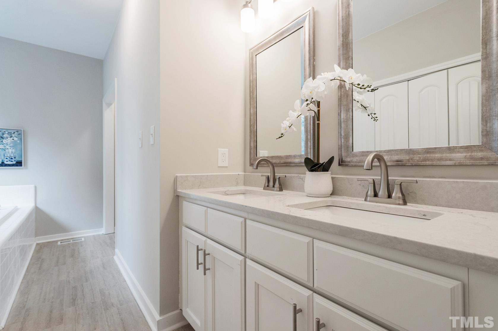 1904 Carthage Circle Raleigh, NC 27604 - Photo 19 of 25 a bathroom with a double vanity sink and a mirror