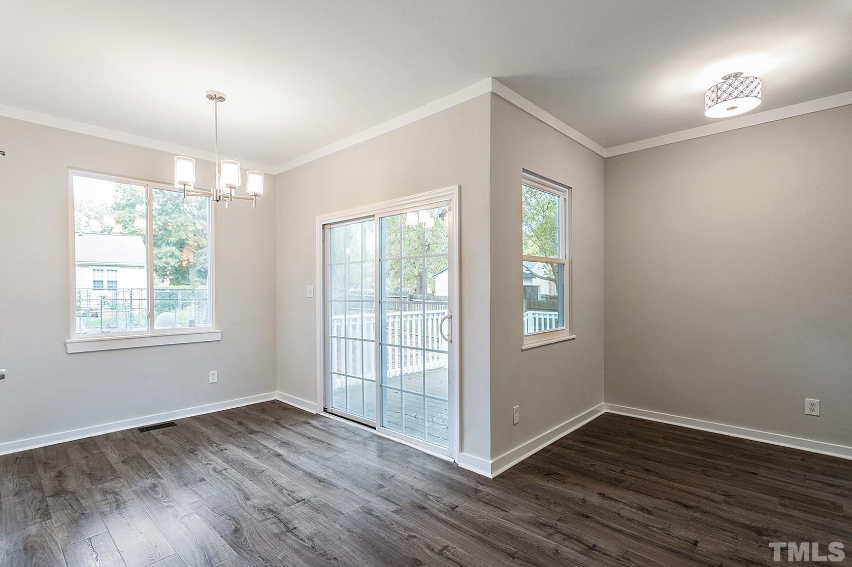 1904 Carthage Circle Raleigh, NC 27604 - Photo 4 of 25 an empty room with wooden floor and windows