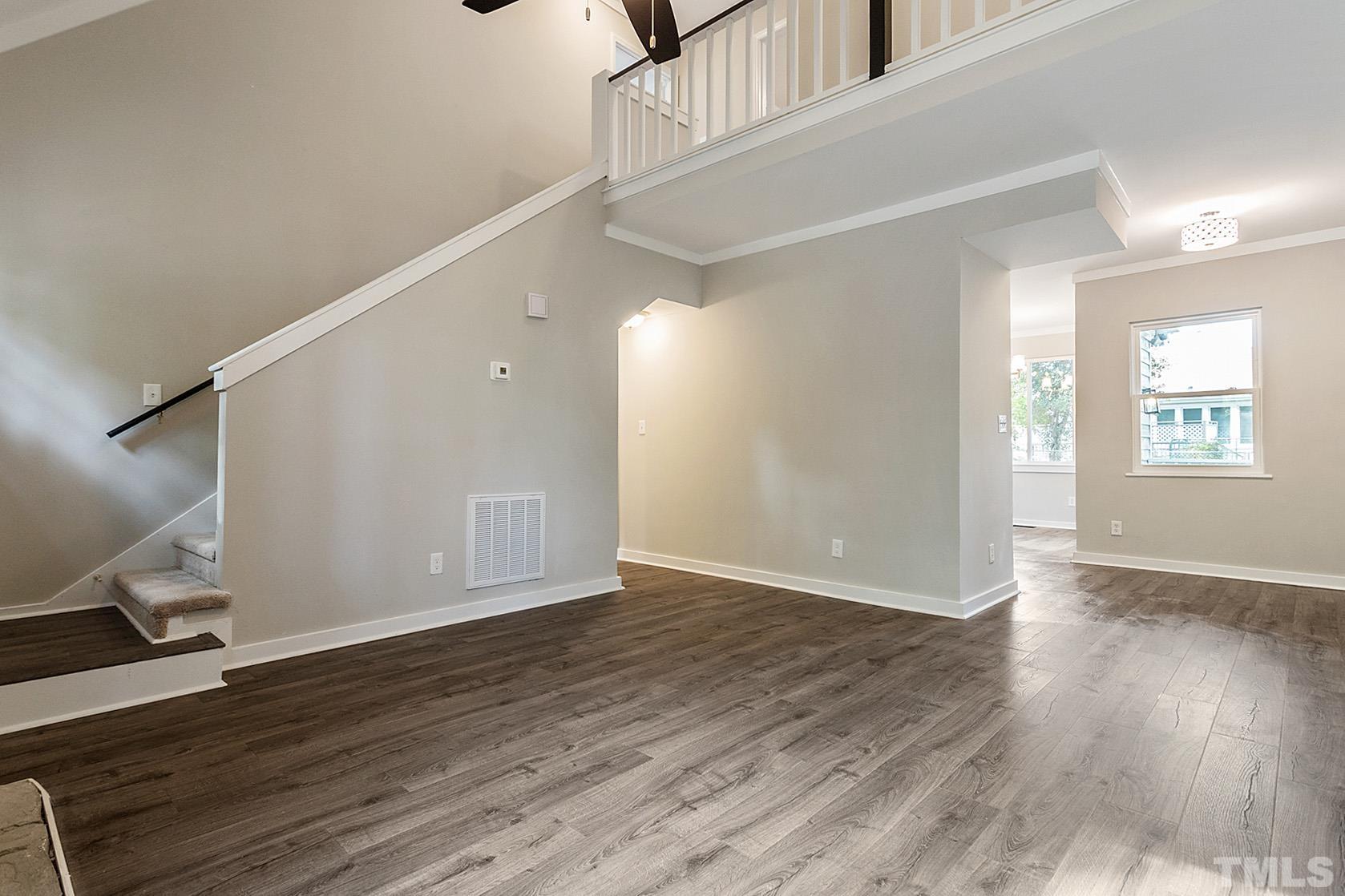 1904 Carthage Circle Raleigh, NC 27604 - Photo 10 of 25 a view of an empty room with wooden floor and a window