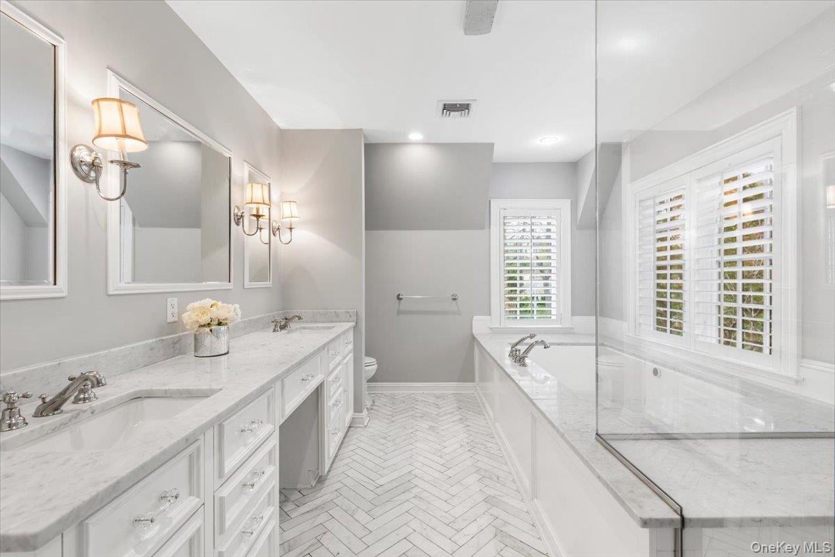 30 Lindbergh Avenue Rye, NY 10580 - Photo 23 of 36 The primary bathroom features double sinks, soaker tub, and a spa shower.