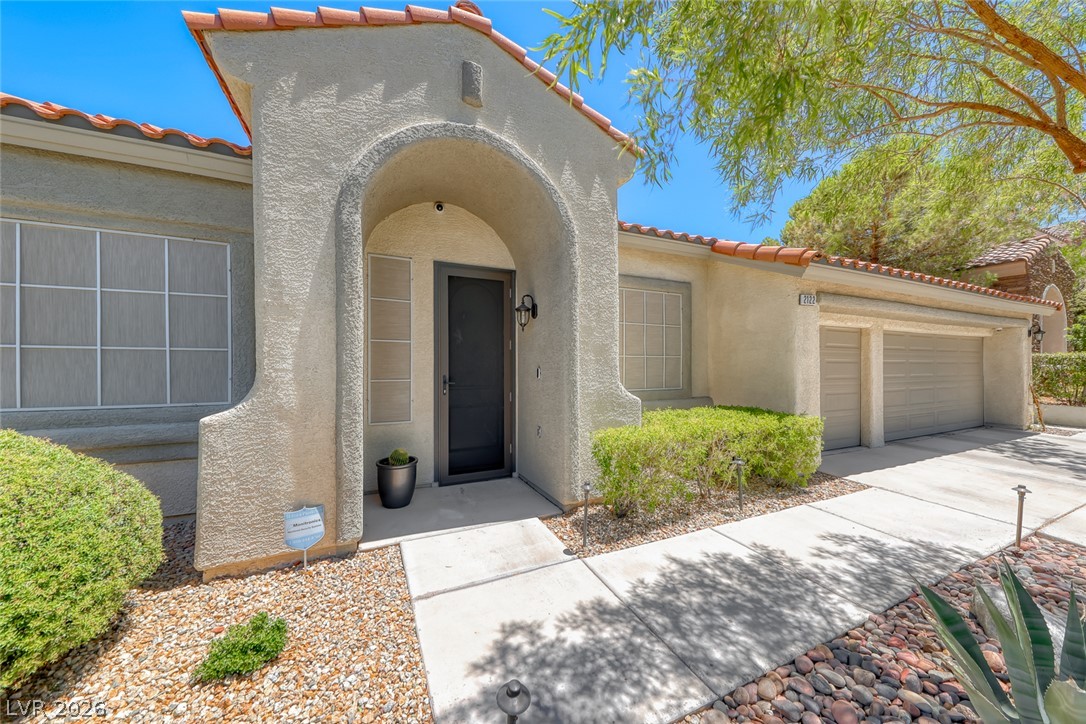 2122 Mooreview Street Henderson, NV 89012 - Photo 3 of 44 An inviting stucco facade with a terracotta-tiled roof welcomes you home.