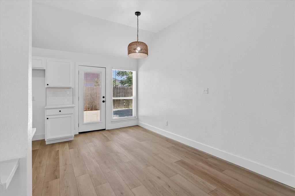 6021 Hartman Road Forest Hill, TX 76119 - Photo 9 of 27 a view of an empty room with a window and wooden floor