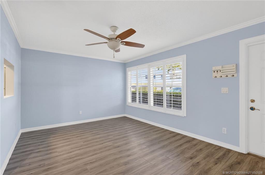 2929 Southeast Ocean Boulevard, Unit J3 Stuart, FL 34996 - Photo 11 of 65 a view of an empty room with wooden floor and a window