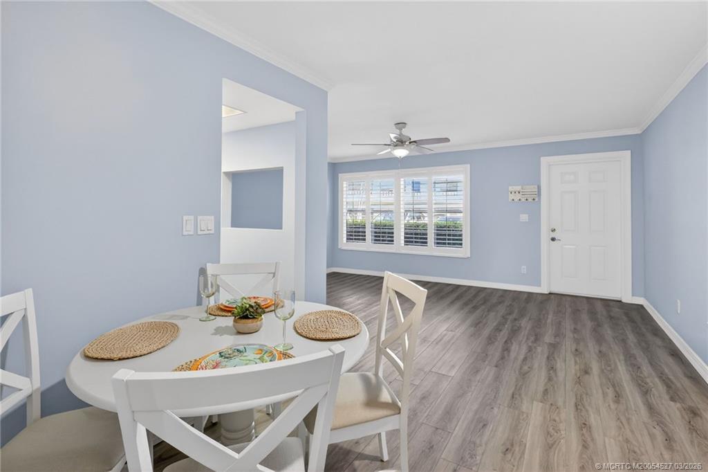 2929 Southeast Ocean Boulevard, Unit J3 Stuart, FL 34996 - Photo 15 of 65 a view of a dining room with furniture window and wooden floor
