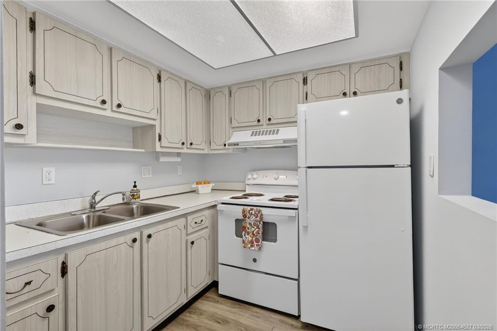 2929 Southeast Ocean Boulevard, Unit J3 Stuart, FL 34996 - Photo 16 of 65 a kitchen with appliances a sink and cabinets