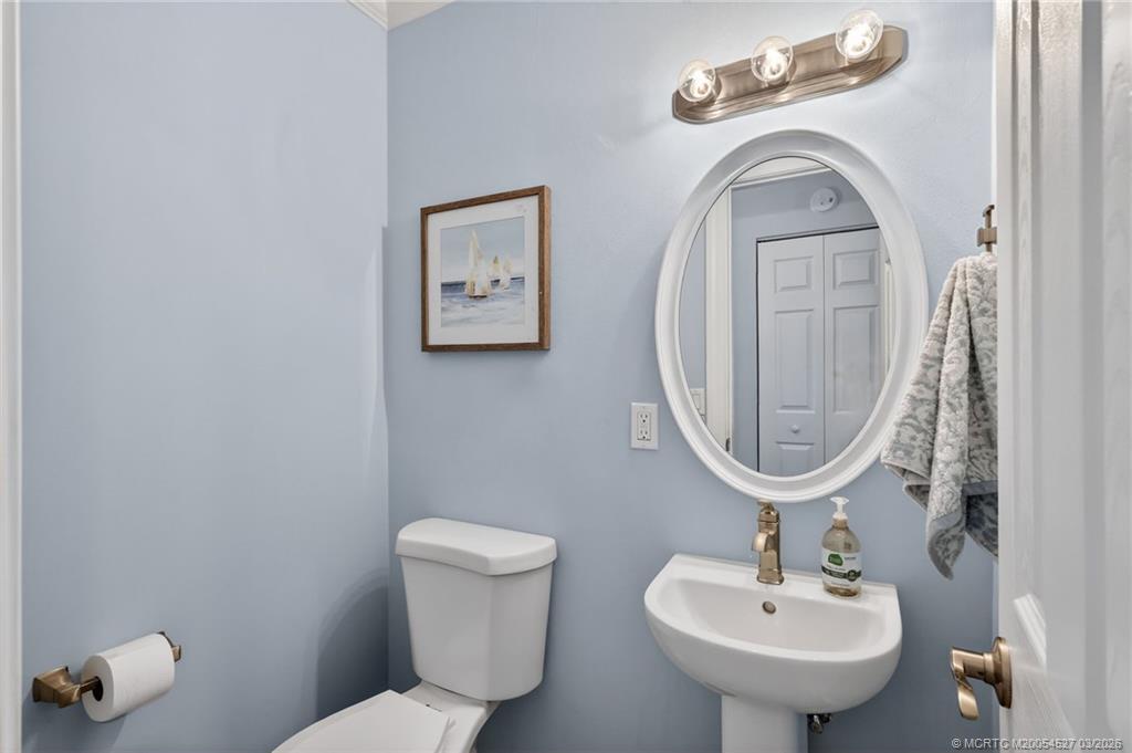 2929 Southeast Ocean Boulevard, Unit J3 Stuart, FL 34996 - Photo 20 of 65 a bathroom with a toilet sink and mirror