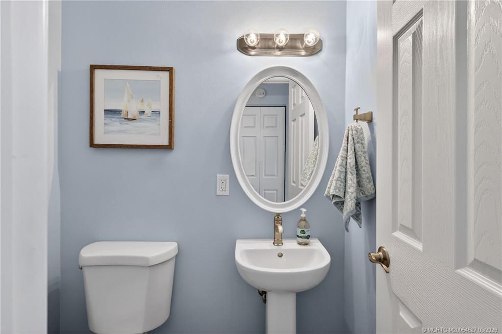 2929 Southeast Ocean Boulevard, Unit J3 Stuart, FL 34996 - Photo 21 of 65 a bathroom with a toilet sink and mirror