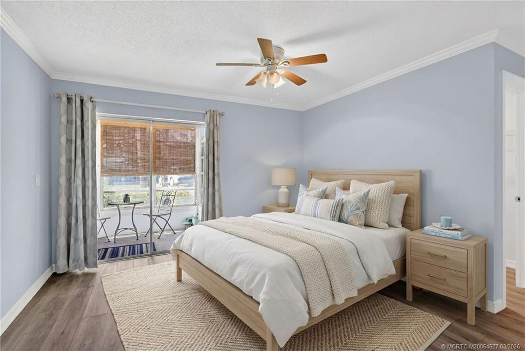 2929 Southeast Ocean Boulevard, Unit J3 Stuart, FL 34996 - Photo 22 of 65 a bedroom with a bed and a large window