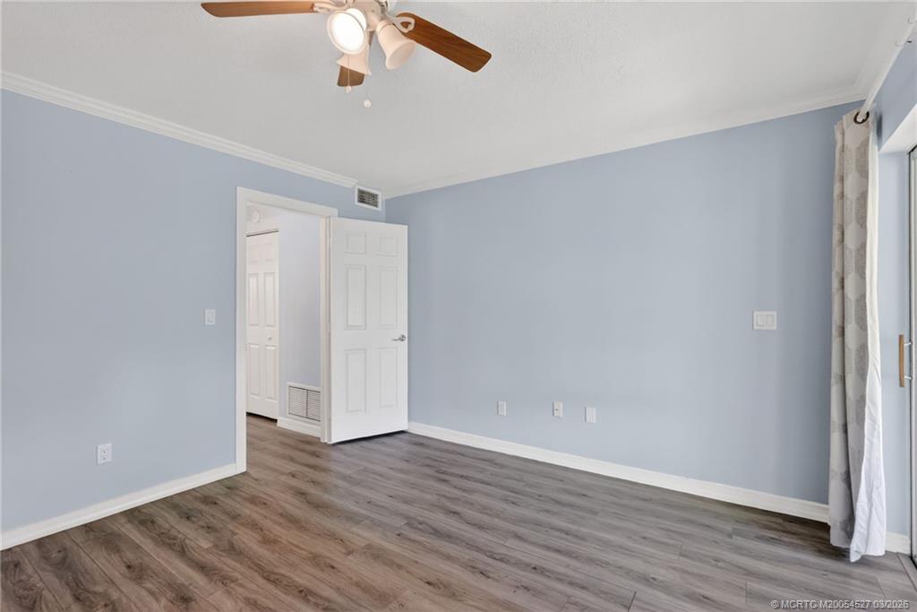 2929 Southeast Ocean Boulevard, Unit J3 Stuart, FL 34996 - Photo 26 of 65 wooden floor in an empty room with a window