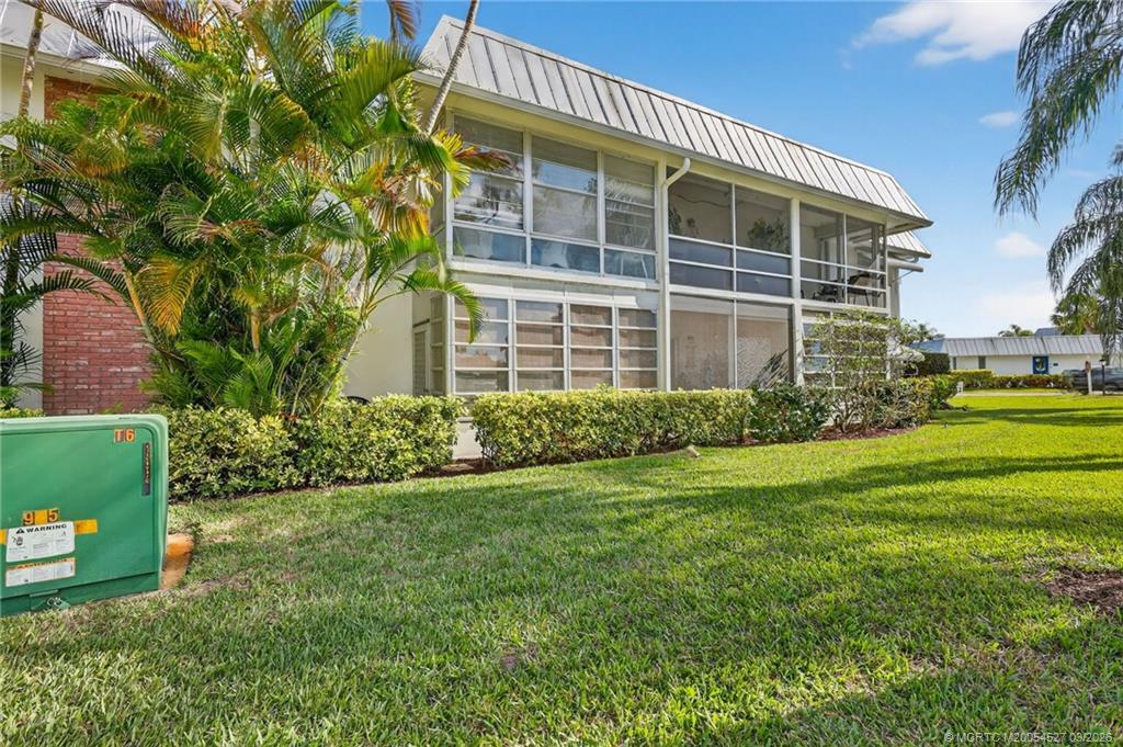 2929 Southeast Ocean Boulevard, Unit J3 Stuart, FL 34996 - Photo 37 of 65 a front view of a house with a yard