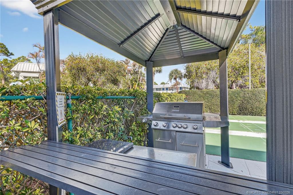 2929 Southeast Ocean Boulevard, Unit J3 Stuart, FL 34996 - Photo 39 of 65 a view of a porch with wooden floor and outdoor space