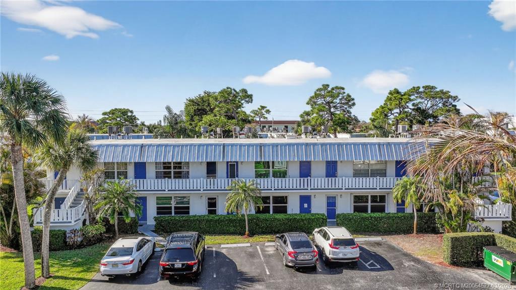 2929 Southeast Ocean Boulevard, Unit J3 Stuart, FL 34996 - Photo 47 of 65 a front view of a house with a garden and street view