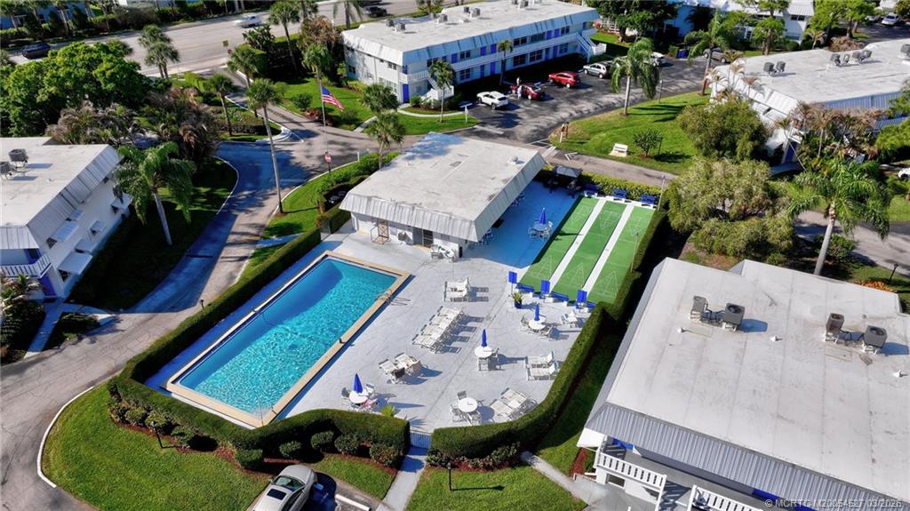 2929 Southeast Ocean Boulevard, Unit J3 Stuart, FL 34996 - Photo 61 of 65 an aerial view of a house with a garden and swimming pool
