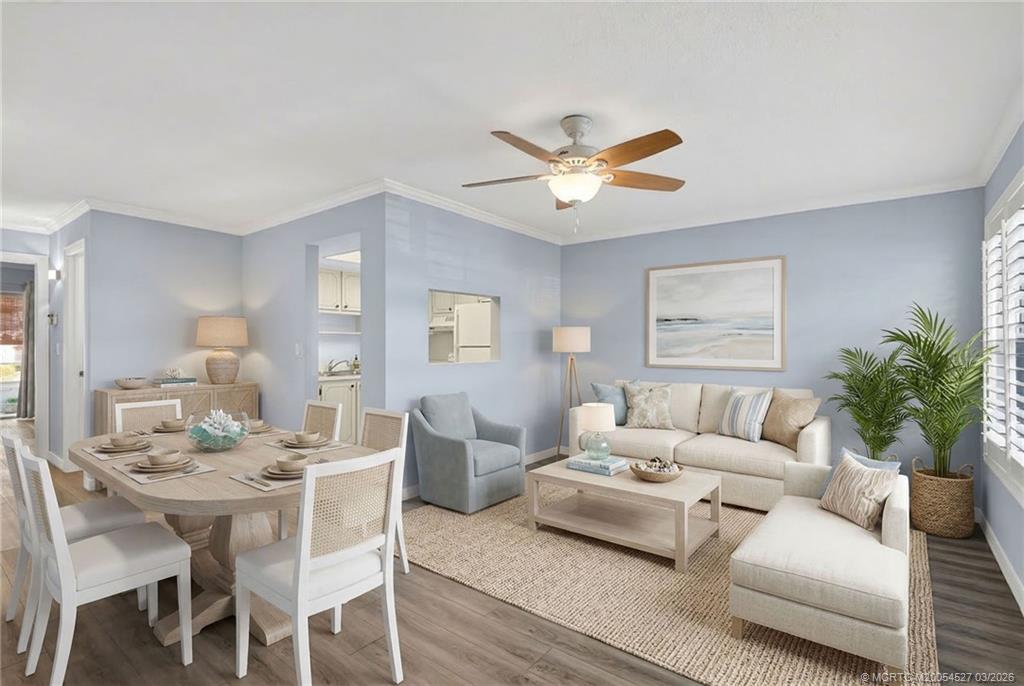 2929 Southeast Ocean Boulevard, Unit J3 Stuart, FL 34996 - Photo 7 of 65 a living room with furniture a chandelier and a window