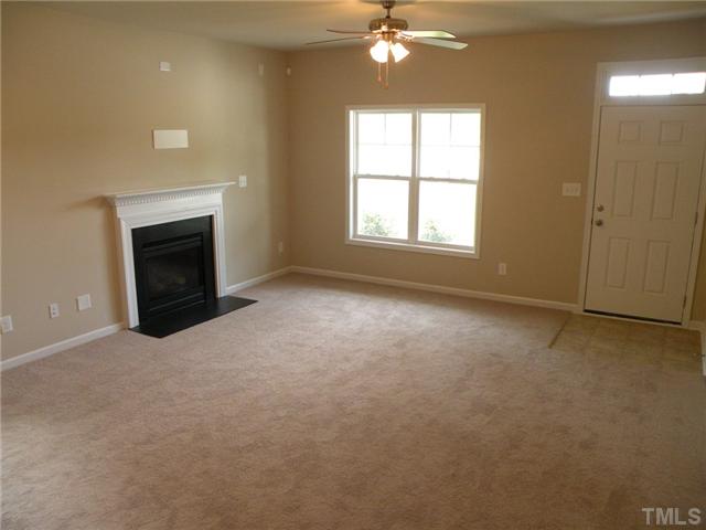 6500 Horseback Lane Raleigh, NC 27610 - Photo 2 of 7 an empty room with chandelier fan and windows