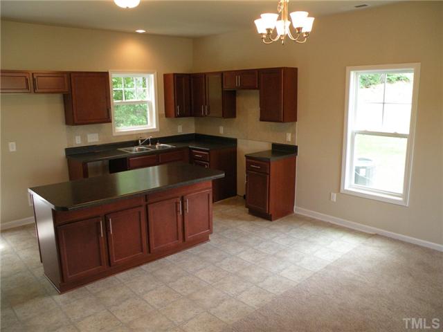 6500 Horseback Lane Raleigh, NC 27610 - Photo 4 of 7 a kitchen with stainless steel appliances granite countertop a sink stove and microwave