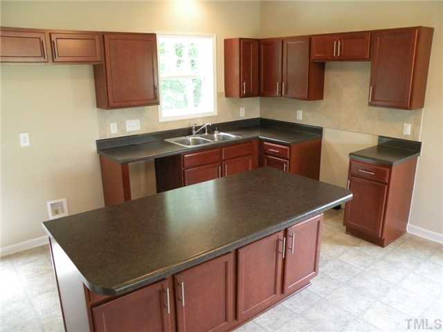 6500 Horseback Lane Raleigh, NC 27610 - Photo 5 of 7 a kitchen with stainless steel appliances granite countertop a sink a stove a microwave a sink and a refrigerator