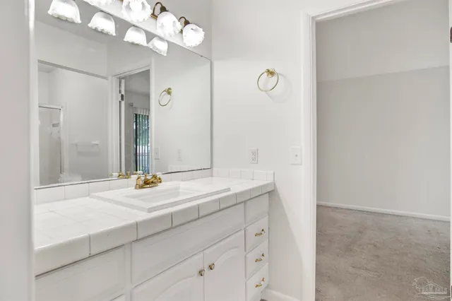 a bathroom with a glass shower door
