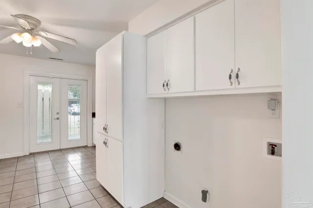 a white stove top oven sitting inside of a kitchen