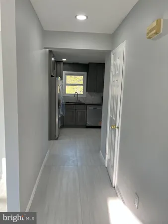 a kitchen with granite countertop cabinets stove and microwave